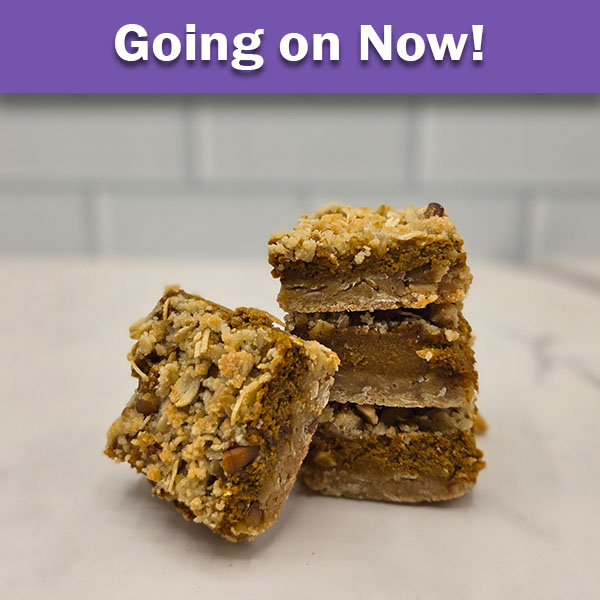 Pumpkin Cream Cheese Bars from Olde Tyme Pastries featuring a crumbly streusel topping, stacked and displayed